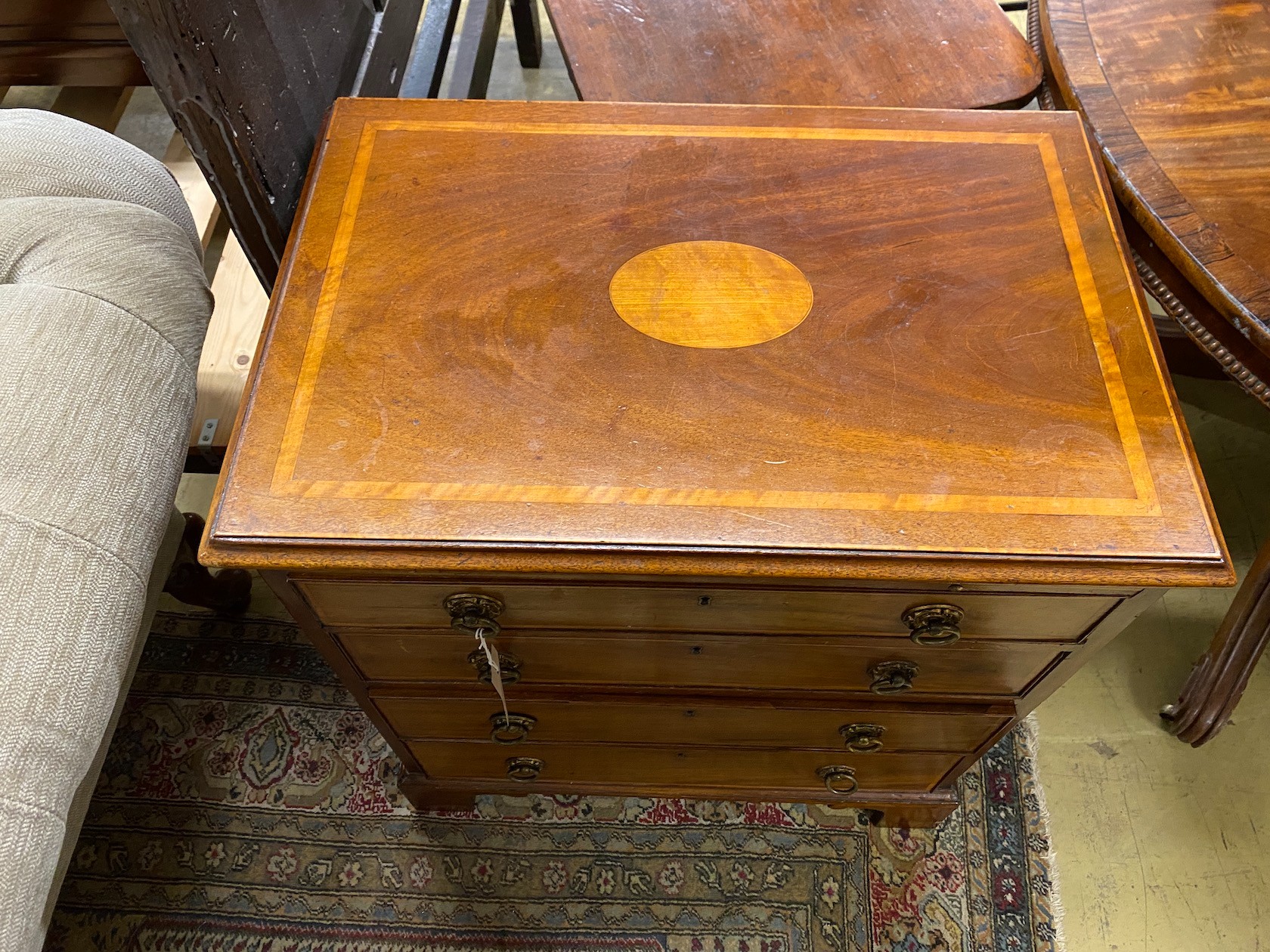A small George III style satinwood inlaid mahogany four drawer chest with slide, width 67cm, depth 44cm, height 75cm
